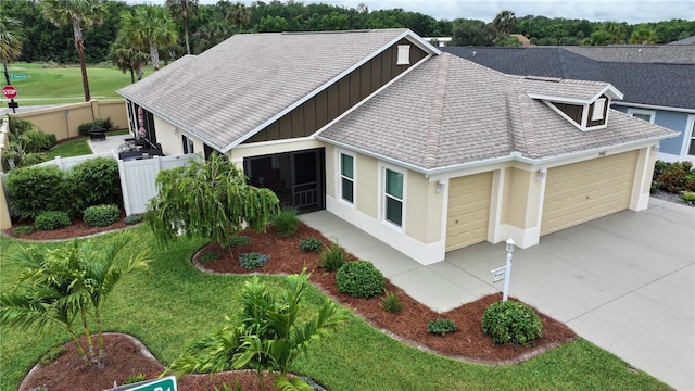 3466 Smedley Rd, The Villages, FL 32163 - view of front of home with a garage, driveway, board and batten siding, and a shingled roof