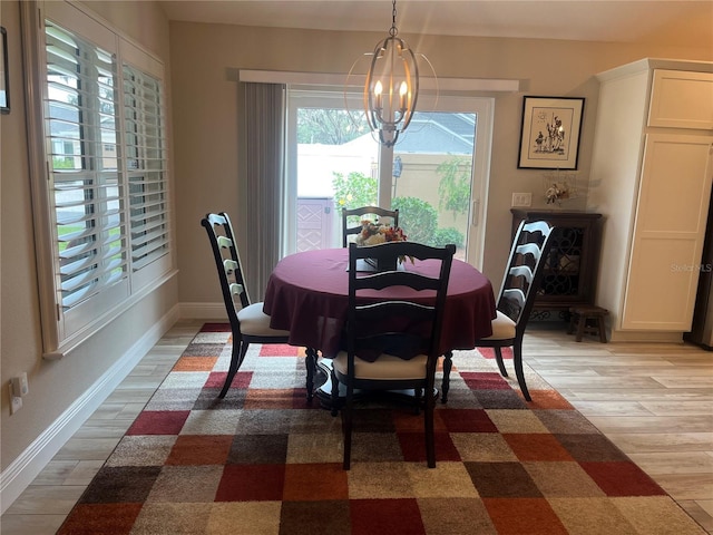3466 Smedley Rd, The Villages, FL 32163 - dining room with a chandelier, light wood-style flooring, and baseboards