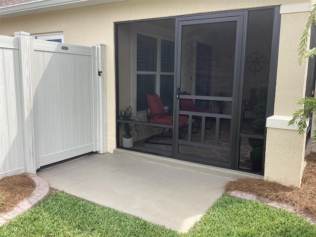 3466 Smedley Rd, The Villages, FL 32163 - view of exterior entry featuring stucco siding and a gate