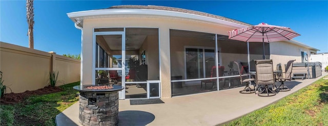 3466 Smedley Rd, The Villages, FL 32163 - rear view of house with a sunroom, a patio, and stucco siding