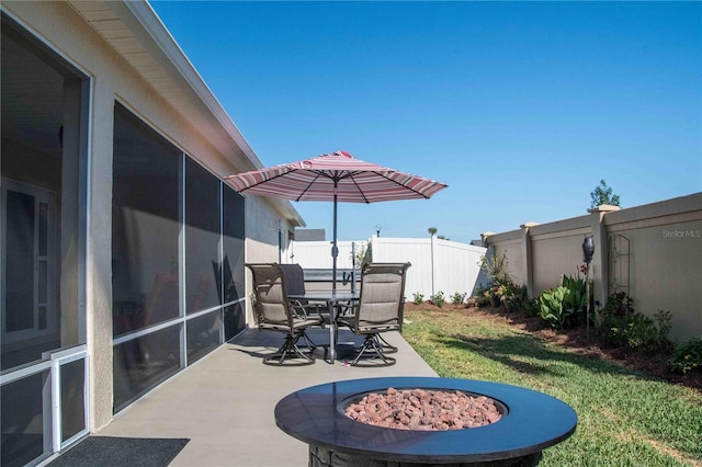 3466 Smedley Rd, The Villages, FL 32163 - view of patio / terrace featuring an outdoor fire pit, outdoor dining area, and a sunroom