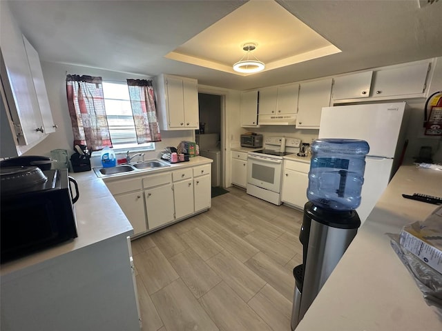 5454-5456 8th Ave, Fort Myers, FL 33907 - kitchen with white appliances, a sink, under cabinet range hood, a raised ceiling, and light countertops