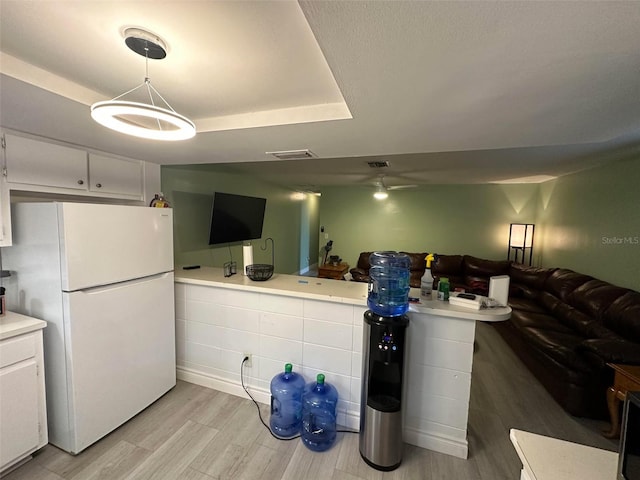 5454-5456 8th Ave, Fort Myers, FL 33907 - kitchen with freestanding refrigerator, light wood-type flooring, light countertops, open floor plan, and white cabinetry