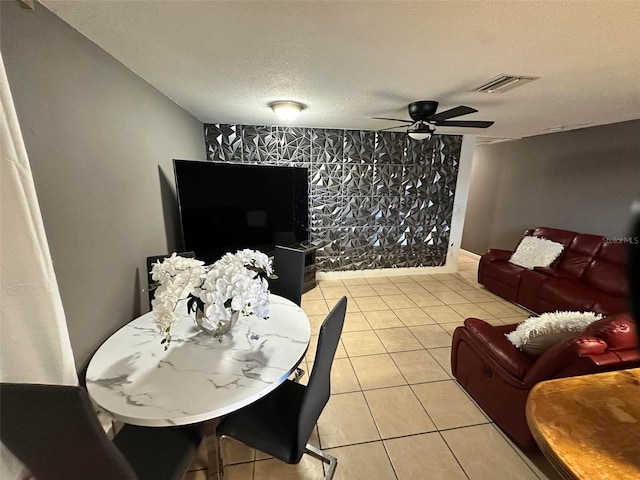 5454-5456 8th Ave, Fort Myers, FL 33907 - living room featuring a ceiling fan, a textured ceiling, light tile patterned floors, and an accent wall