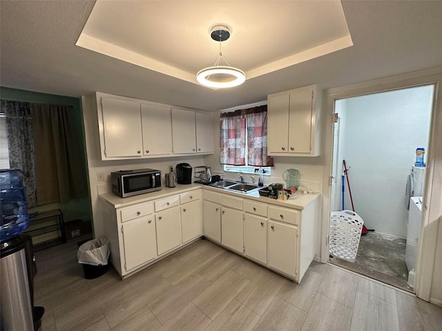 5454-5456 8th Ave, Fort Myers, FL 33907 - kitchen featuring stainless steel microwave, a tray ceiling, a sink, and white cabinets