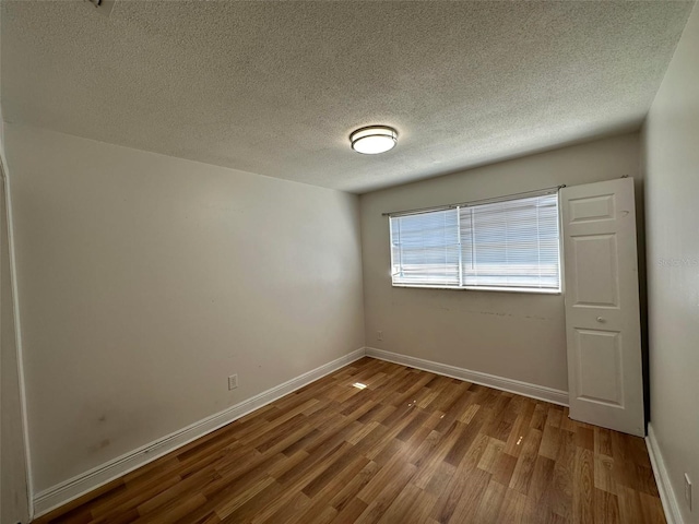 5454-5456 8th Ave, Fort Myers, FL 33907 - unfurnished room featuring wood finished floors, a textured ceiling, and baseboards