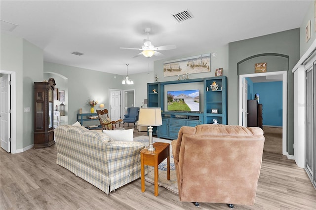 3978 Nottingham Loop, The Villages, FL 32163 - living area with ceiling fan, light wood finished floors, arched walkways, and baseboards