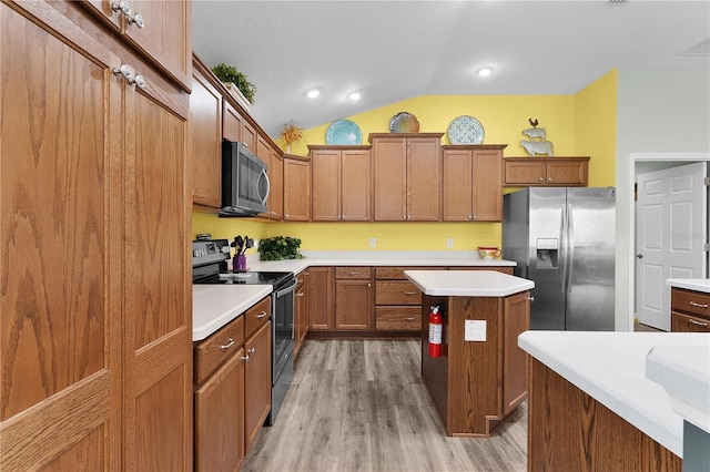 3978 Nottingham Loop, The Villages, FL 32163 - kitchen featuring stainless steel appliances, lofted ceiling, light wood finished floors, brown cabinets, and light countertops