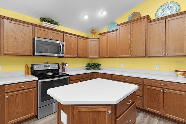 3978 Nottingham Loop, The Villages, FL 32163 - kitchen with appliances with stainless steel finishes, light wood-type flooring, lofted ceiling, brown cabinets, and recessed lighting