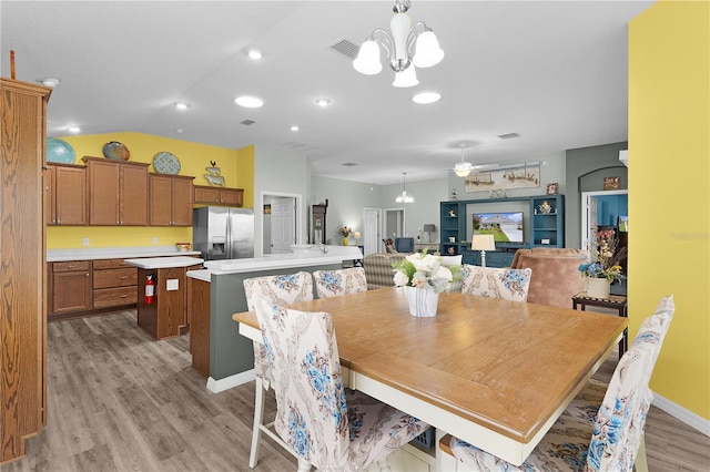 3978 Nottingham Loop, The Villages, FL 32163 - dining room featuring a chandelier, light wood-type flooring, lofted ceiling, and a ceiling fan