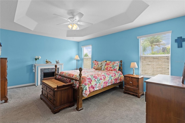 3978 Nottingham Loop, The Villages, FL 32163 - bedroom with light colored carpet, a ceiling fan, and a tray ceiling