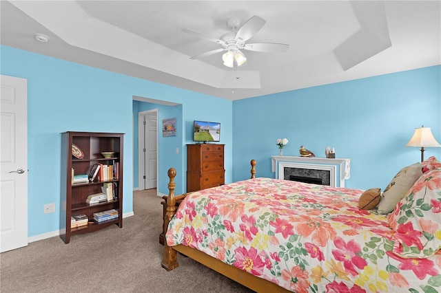 3978 Nottingham Loop, The Villages, FL 32163 - carpeted bedroom featuring a tray ceiling, baseboards, and ceiling fan