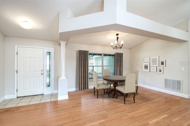 832 Willow Run St, Minneola, FL 34715 - dining area with ornate columns, light wood-style flooring, a chandelier, and lofted ceiling