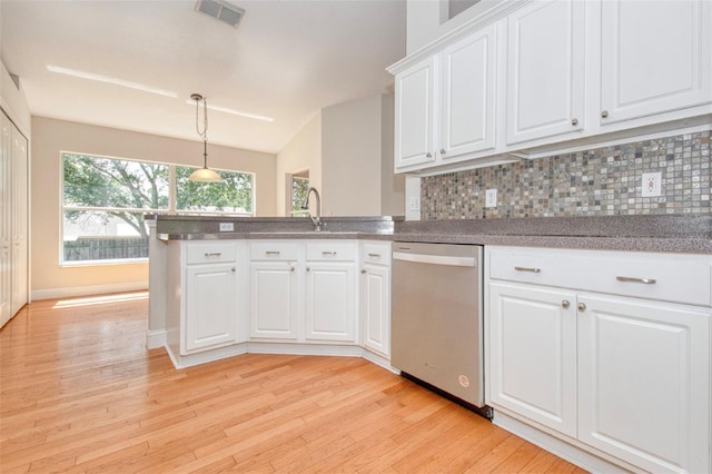832 Willow Run St, Minneola, FL 34715 - kitchen with dishwasher, light wood-style floors, decorative backsplash, and white cabinets