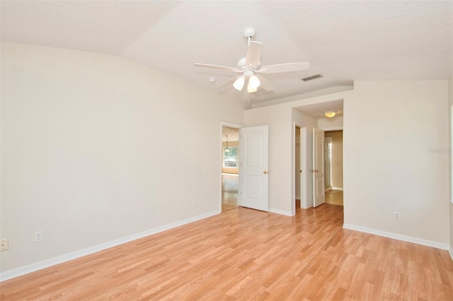 832 Willow Run St, Minneola, FL 34715 - empty room featuring light wood-style floors, lofted ceiling, and a ceiling fan