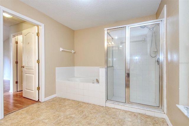 832 Willow Run St, Minneola, FL 34715 - bathroom featuring a garden tub, a stall shower, tile patterned flooring, and a textured ceiling