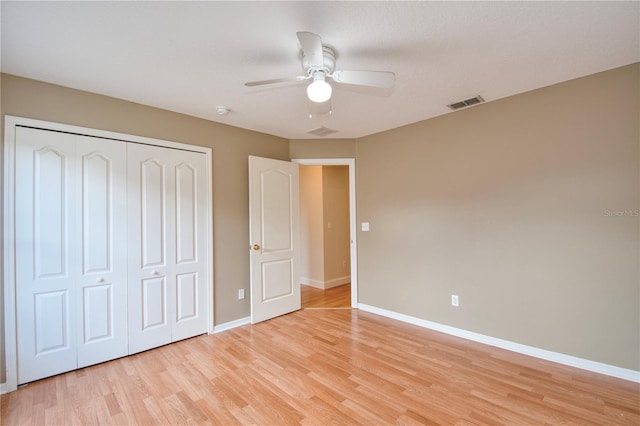 832 Willow Run St, Minneola, FL 34715 - unfurnished bedroom with light wood-style flooring, a closet, and a ceiling fan