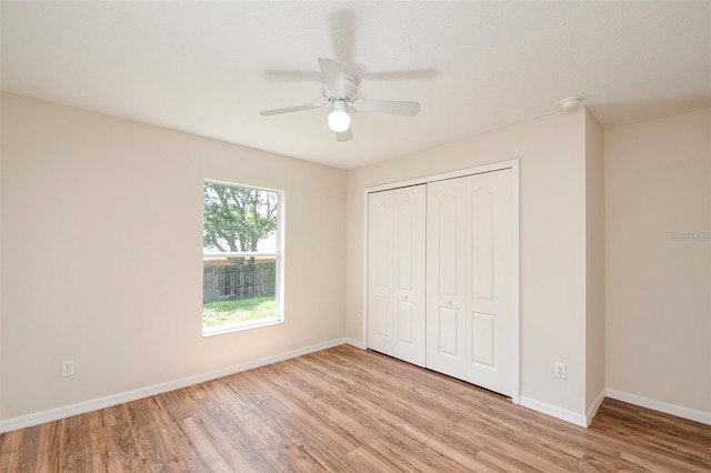832 Willow Run St, Minneola, FL 34715 - unfurnished bedroom with wood finished floors, a closet, and a ceiling fan