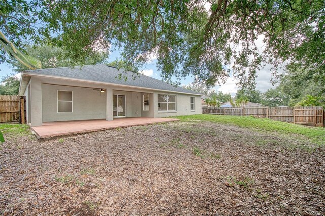 832 Willow Run St, Minneola, FL 34715 - back of house featuring a fenced backyard, ceiling fan, stucco siding, a patio, and a shingled roof