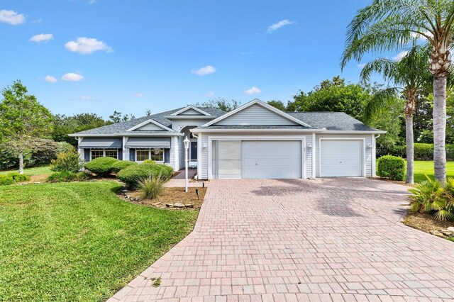 2991 Saint Thomas Ln, The Villages, FL 32162 - single story home featuring decorative driveway, a garage, a front yard, and roof with shingles