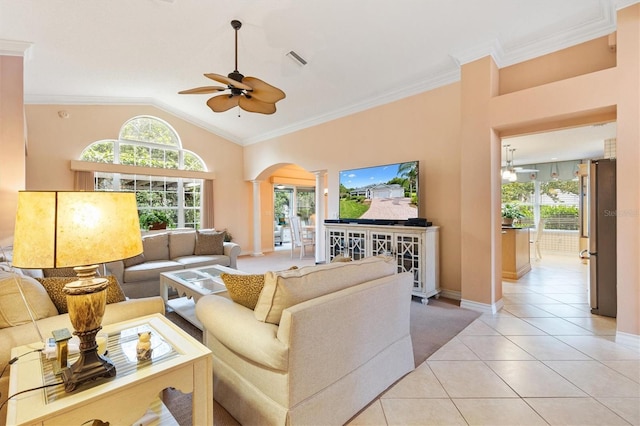 2991 Saint Thomas Ln, The Villages, FL 32162 - living area featuring ornate columns, arched walkways, a ceiling fan, light tile patterned flooring, and plenty of natural light