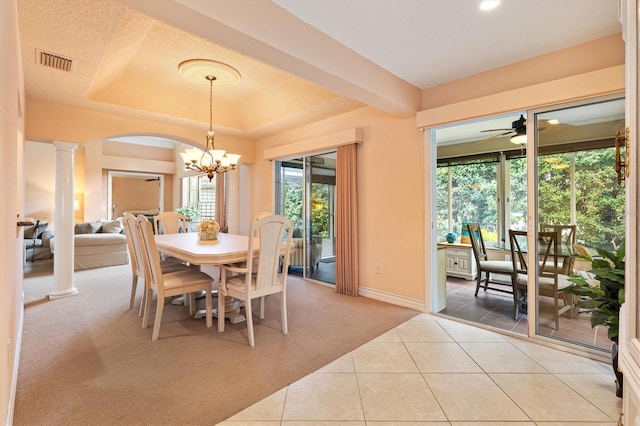 2991 Saint Thomas Ln, The Villages, FL 32162 - dining area with light carpet, decorative columns, a chandelier, baseboards, and light tile patterned flooring