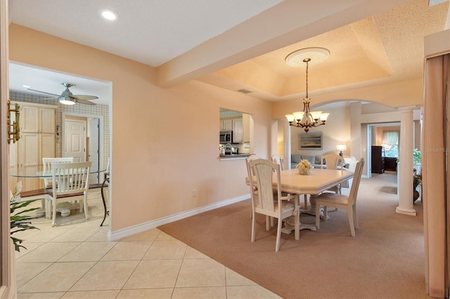 2991 Saint Thomas Ln, The Villages, FL 32162 - dining space featuring ornate columns, baseboards, arched walkways, light colored carpet, and a chandelier
