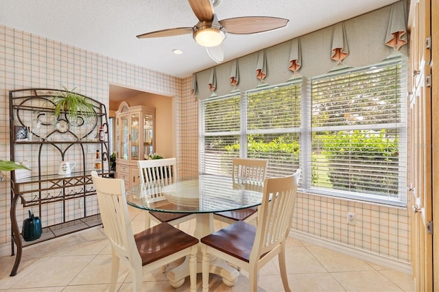 2991 Saint Thomas Ln, The Villages, FL 32162 - dining space with wallpapered walls, light tile patterned floors, ceiling fan, and a textured ceiling
