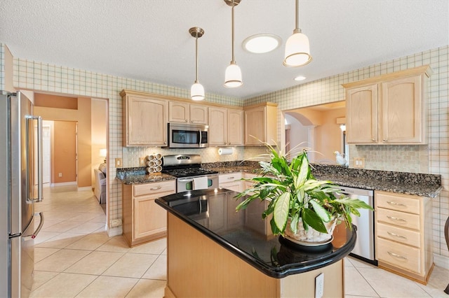 2991 Saint Thomas Ln, The Villages, FL 32162 - kitchen featuring stainless steel appliances, light brown cabinets, a kitchen island, wallpapered walls, and light tile patterned flooring