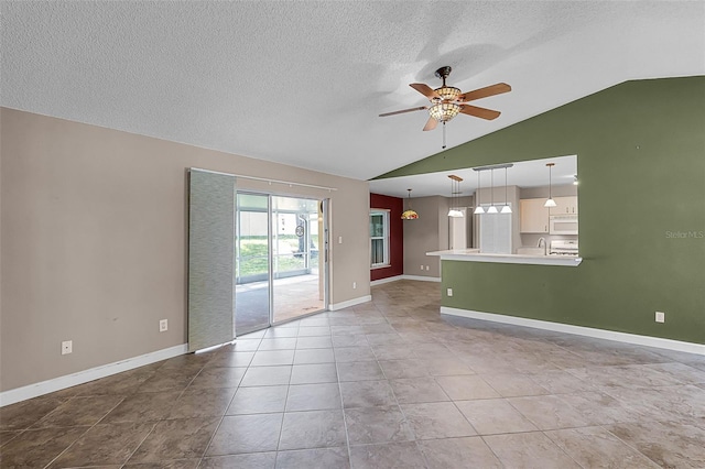 15916 Indian Wells Ct, Clermont, FL 34711 - unfurnished living room with lofted ceiling, a ceiling fan, a textured ceiling, baseboards, and light tile patterned flooring