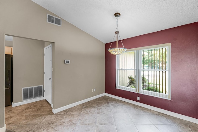 15916 Indian Wells Ct, Clermont, FL 34711 - spare room featuring vaulted ceiling, a textured ceiling, baseboards, and light tile patterned floors