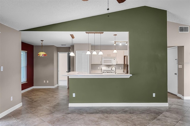 15916 Indian Wells Ct, Clermont, FL 34711 - kitchen with white microwave, white cabinets, ceiling fan, light countertops, and freestanding refrigerator