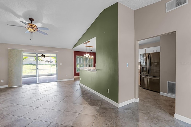 15916 Indian Wells Ct, Clermont, FL 34711 - empty room featuring ceiling fan, a chandelier, baseboards, high vaulted ceiling, and a textured ceiling