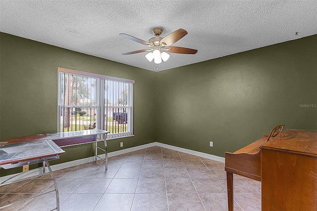 15916 Indian Wells Ct, Clermont, FL 34711 - empty room featuring a ceiling fan, a textured ceiling, light tile patterned flooring, and baseboards