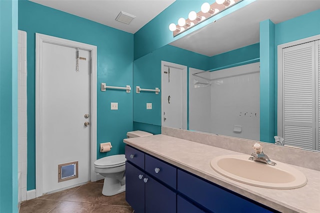 15916 Indian Wells Ct, Clermont, FL 34711 - bathroom with toilet, vanity, a closet, tile patterned floors, and a shower