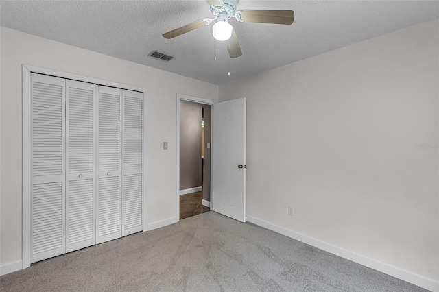 15916 Indian Wells Ct, Clermont, FL 34711 - unfurnished bedroom featuring baseboards, a textured ceiling, carpet floors, a closet, and a ceiling fan