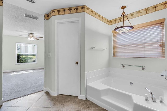 15916 Indian Wells Ct, Clermont, FL 34711 - bathroom with a garden tub, ceiling fan, tile patterned flooring, and baseboards