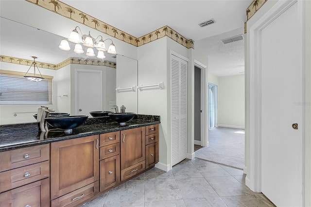 15916 Indian Wells Ct, Clermont, FL 34711 - full bathroom featuring double vanity, baseboards, and a closet