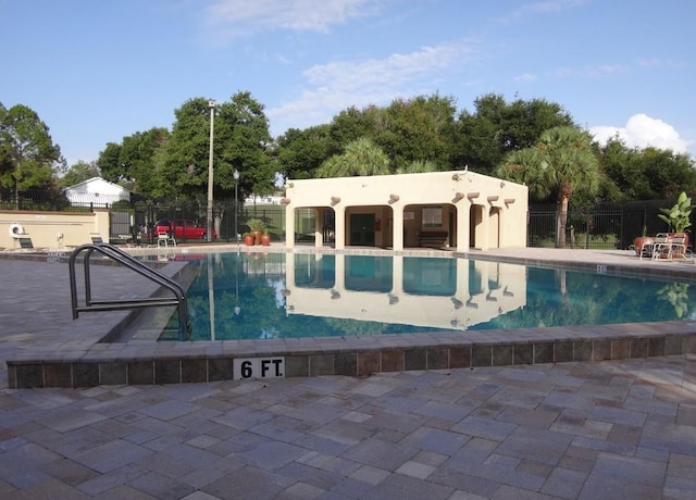 15916 Indian Wells Ct, Clermont, FL 34711 - community pool featuring a patio area