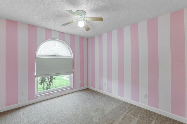 15916 Indian Wells Ct, Clermont, FL 34711 - spare room with carpet floors, a textured ceiling, wallpapered walls, a ceiling fan, and baseboards