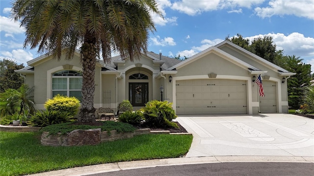 1553 Lynchburg Loop, The Villages, FL 32162 - view of front of property featuring stucco siding, an attached garage, and concrete driveway