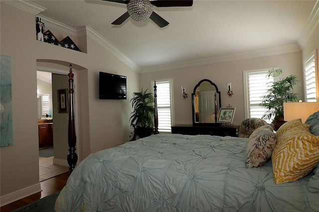 1553 Lynchburg Loop, The Villages, FL 32162 - bedroom featuring multiple windows, vaulted ceiling, wood finished floors, arched walkways, and baseboards