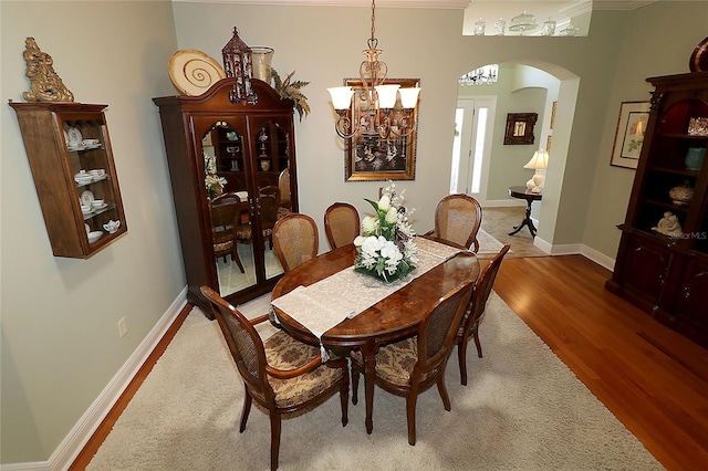 1553 Lynchburg Loop, The Villages, FL 32162 - dining room featuring arched walkways, a chandelier, wood finished floors, and baseboards