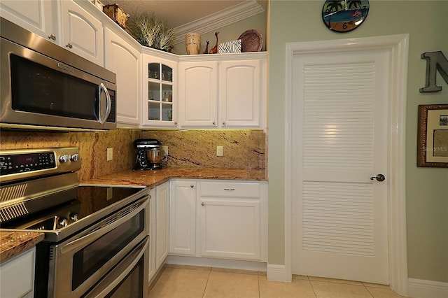 1553 Lynchburg Loop, The Villages, FL 32162 - kitchen with stainless steel appliances, light tile patterned floors, white cabinets, stone countertops, and ornamental molding
