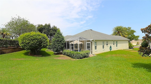 1553 Lynchburg Loop, The Villages, FL 32162 - rear view of property featuring a yard