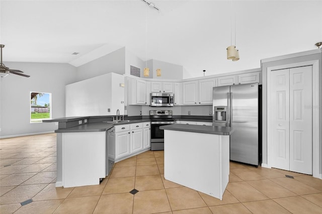 2705 Bayview Dr, Eustis, FL 32726 - kitchen with appliances with stainless steel finishes, dark countertops, a sink, a peninsula, and high vaulted ceiling