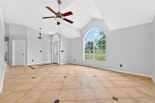 2705 Bayview Dr, Eustis, FL 32726 - unfurnished living room with ceiling fan, light tile patterned floors, high vaulted ceiling, and baseboards