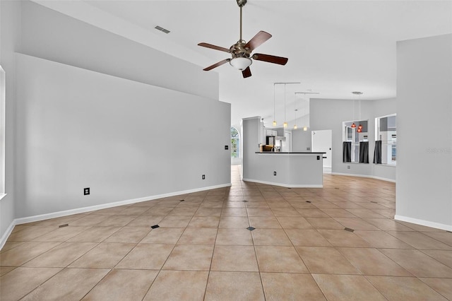 2705 Bayview Dr, Eustis, FL 32726 - unfurnished living room with a ceiling fan, high vaulted ceiling, light tile patterned flooring, and baseboards