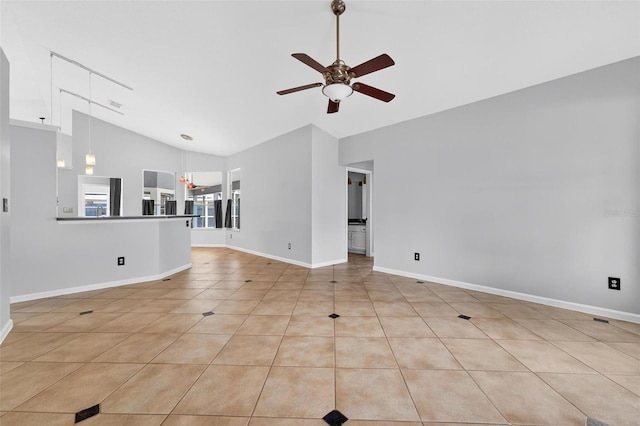 2705 Bayview Dr, Eustis, FL 32726 - unfurnished living room with ceiling fan, high vaulted ceiling, baseboards, and light tile patterned floors