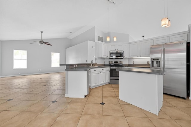 2705 Bayview Dr, Eustis, FL 32726 - kitchen featuring stainless steel appliances, dark countertops, a peninsula, light tile patterned floors, and ceiling fan